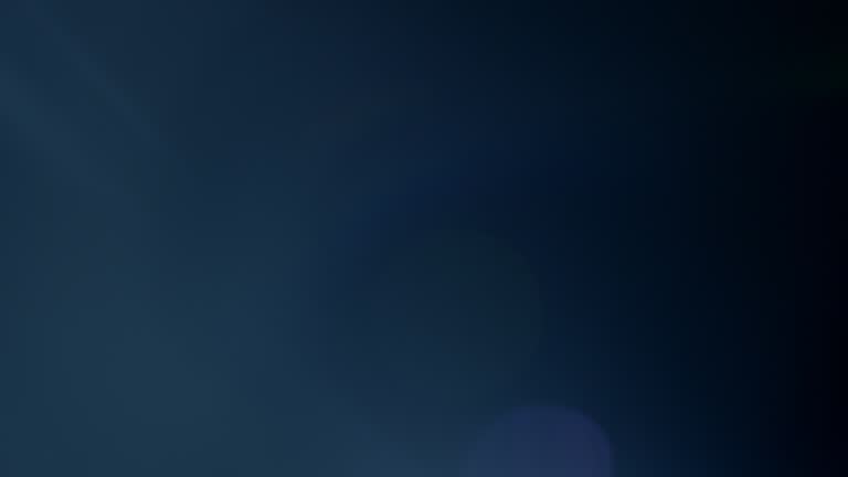 Series of blue light lens flares originating from screen left.